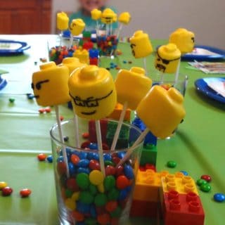Hosting a Lego themed birthday party? Try this Lego Head Marshmallow Pops Recipe; they are an easy and adorable way to add Lego head decorations to your table and treat bags.