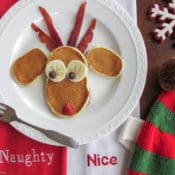 Simple Breakfast Recipe: Reindeer Christmas Pancakes - This simple breakfast recipe for Reindeer Christmas pancakes is easy to make and looks adorable! Imagine all of Santa’s elves lining up for a delicious breakfast of fluffy reindeer pancakes before they head out for a tough day at the toy factory. The batter is made with Greek yogurt and honey, making them healthy but still sweet enough to eat with or without syrup.