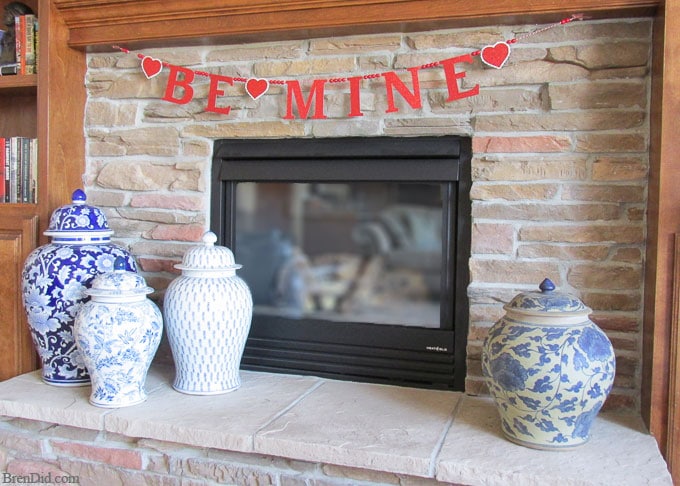 Get ready for Valentine's Day parties and events with this glitter garland inspired by Pottery Barn Kids. This easy Knock Off DIY craft uses glitter cardstock, some twine, and wooden beads to make a charming Valentine's Day banner for under $3.