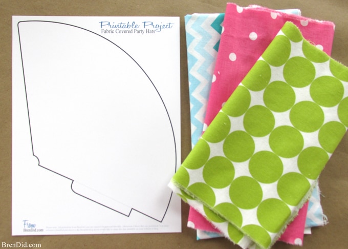 Fabric covered party hats are an easy craft and an affordable way to take your birthday party decor to the next level. With a little patterned fabric, glue, yarn and card stock you can turn a common party decoration into something extraordinary.