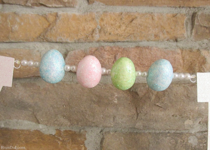 Pottery Barn Kids inspired glitter Happy Easter banner made from cardstock, twine, beads, and glitter styrofoam eggs. Takes only a few minutes to assemble and cost $4.00! Add a special touch to your Easter décor.