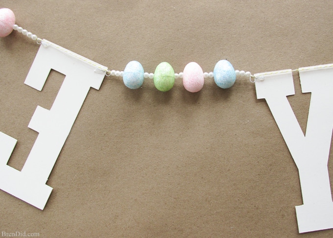 Pottery Barn Kids inspired glitter Happy Easter banner made from cardstock, twine, beads, and glitter styrofoam eggs. Takes only a few minutes to assemble and cost $4.00! Add a special touch to your Easter décor.