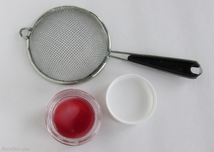 DIY Sweet Strawberry Lip Balm recipe uses simple, all-natural ingredients including real strawberries to make a lightly tinted and flavored lip gloss. Free printable label. Must try! 