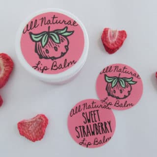 DIY Sweet Strawberry Lip Balm recipe uses simple, all-natural ingredients including real strawberries to make a lightly tinted and flavored lip gloss. Free printable label. Must try!