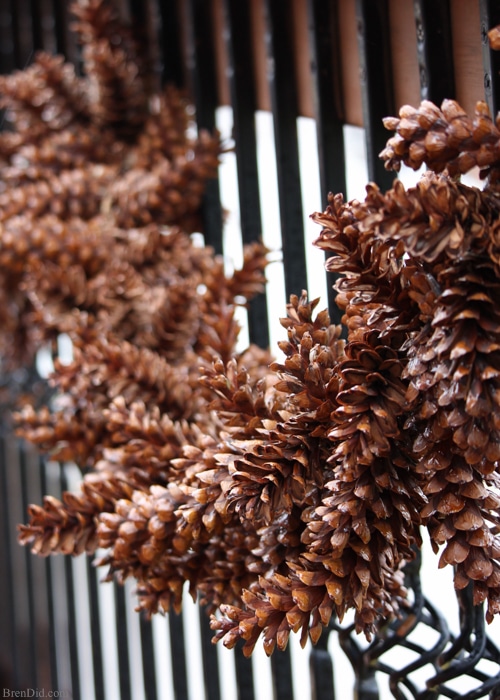 Learn how to make an pine cone garland for a touch of woodland style. This easy tutorial shows you how to create your own easy pine cone garland for less than $1.30 per foot. Eco-friendly.