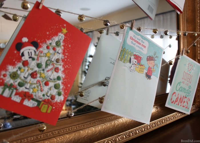 Enjoy your holiday cards all season long with this easy DIY Jingle Bell Garland Christmas Card Display. A 20 minute Christmas DIY project. 