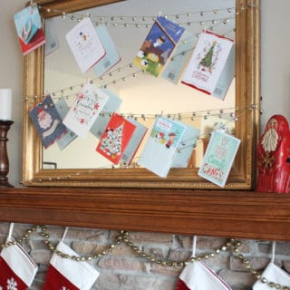 Enjoy your holiday cards all season long with this easy DIY Jingle Bell Garland Christmas Card Display. A 20 minute Christmas DIY project.