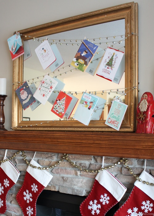 Enjoy your holiday cards all season long with this easy DIY Jingle Bell Garland Christmas Card Display. A 20 minute Christmas DIY project. 