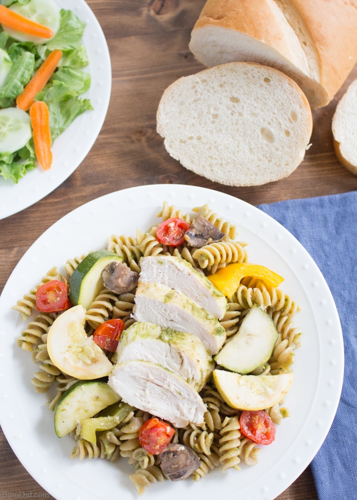 Chicken Pesto Pasta Easy Crockpot Recipe: This throw & go crock pot recipe features basil pesto, chicken, roast vegetable, and chicken. Serve it with pasta for a healthy and tasty dinner that takes just minutes to prepare. 