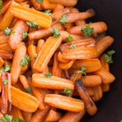 Roasted carrots are cooked in a light sauce of butter, honey, ginger, and lemon. The oven brings out the naturally sweet flavor of the roasted carrots and turns the sauce into a tasty glaze.