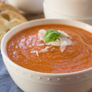 Creamy, comforting, and cheesy this healthy slow cooker tomato basil parmesan soup is packed with vegetables that give it incredible flavor without all the fat and calories. Shhh… no one will know it’s anything but delicious creamy tomato soup!