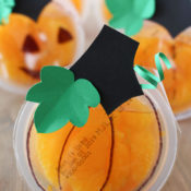orange fruit cup decorated to look like pumpkins
