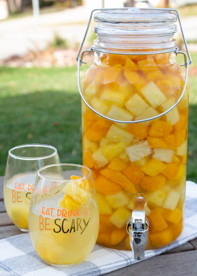 Layered Halloween sangria recipe with pineapple and mango and glasses