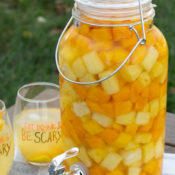 orange and yellow sangria recipe served in a dispenser