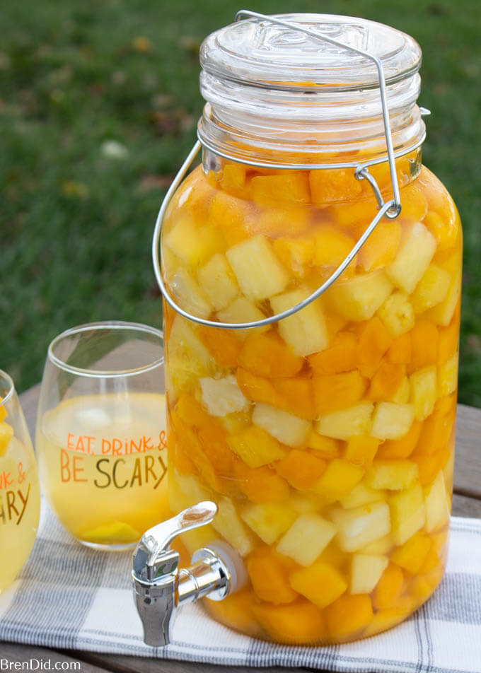 orange and yellow sangria recipe served in a dispenser