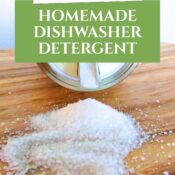 A clear glass mason jar filled with white homemade dishwasher detergent powder,
