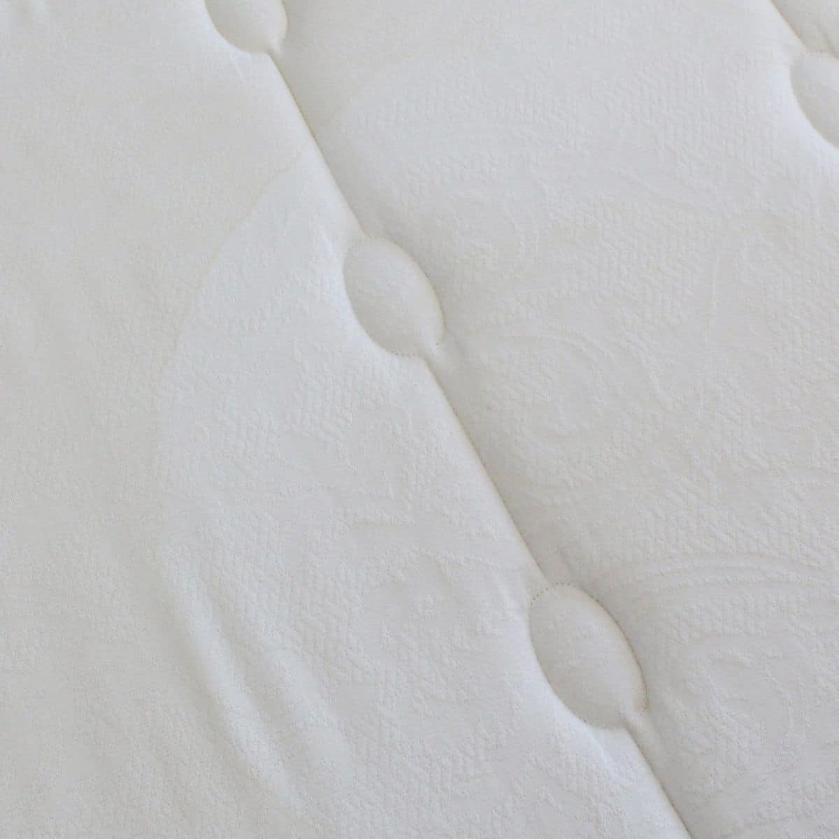 Yellow sweat stains on a white mattress before natural cleaning.